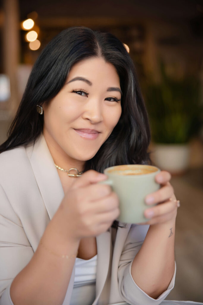 woman holding a pistachio green mug in Pacha Collective coffee shop
