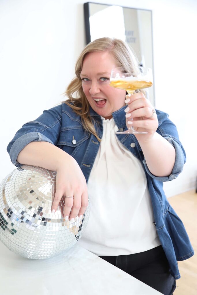 Megan cheers you on to build your brand while resting against a disco ball